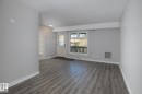 Spacious room with wood-finish flooring, light grey walls, and white trim - 5816 172 Street, Edmonton, AB  - Indoor Photo Showing Other Room 