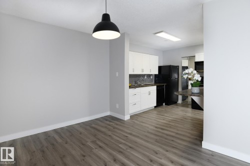 Open-concept living space with wood-finish flooring - 5816 172 Street, Edmonton, AB - Indoor Photo Showing Kitchen