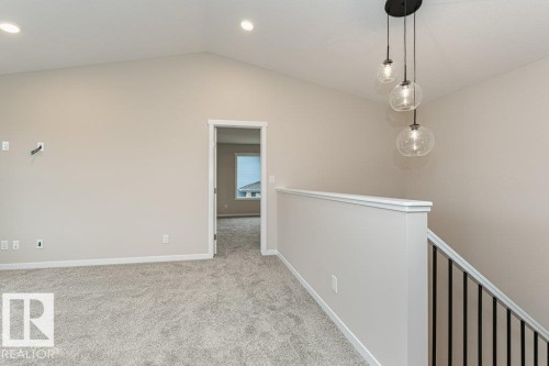 Carpeted upper-level space featuring a vaulted ceiling and recessed lighting - 2616 158 Street, Edmonton, AB - Indoor Photo Showing Other Room