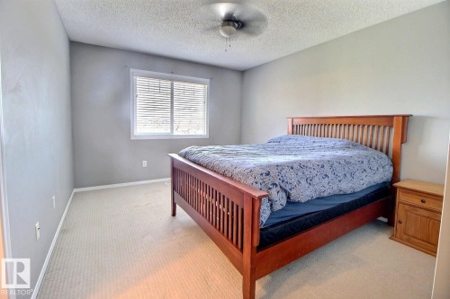 Carpeted room with a ceiling fan, a window featuring blinds, and light-toned walls - 170 Keystone Crescent, Leduc, AB - Indoor Photo Showing Bedroom