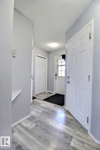 Entryway featuring light wood-finish flooring, white trim, and light gray walls - 170 Keystone Crescent, Leduc, AB - Indoor Photo Showing Other Room