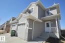 Two-story residence featuring light gray siding, white trim, and a prominent front entrance with a small porch - 170 Keystone Crescent, Leduc, AB  - Outdoor 