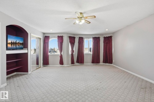 This room features bay windows with drapes, recessed lighting, a ceiling fan, and carpeted flooring - 4831 154 Avenue, Edmonton, AB - Indoor