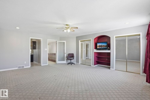 Spacious room featuring patterned carpeting, light gray walls, a ceiling fan, and recessed lighting - 4831 154 Avenue, Edmonton, AB - Indoor