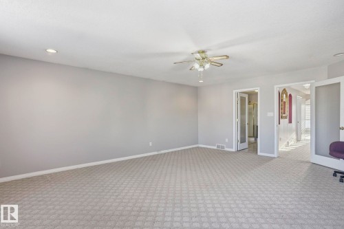 Spacious interior featuring patterned carpeting, recessed lighting, and a ceiling fan - 4831 154 Avenue, Edmonton, AB - Indoor Photo Showing Other Room