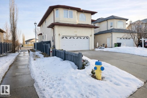 The property features a two-story exterior with a garage and a paved driveway - 4831 154 Avenue, Edmonton, AB - Outdoor