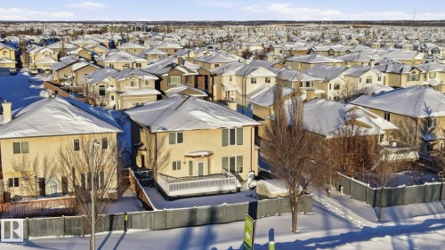 The property features a two-story exterior with a deck, a fenced yard, and an expansive neighborhood setting - 4831 154 Avenue, Edmonton, AB - Outdoor