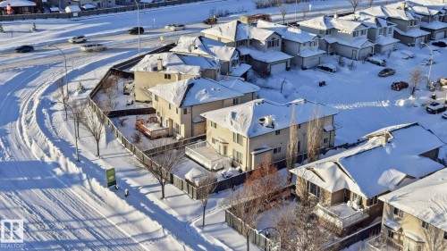 Residential homes featuring pitched roofs, some with visible chimneys, and surrounding yards - 4831 154 Avenue, Edmonton, AB - Outdoor With View