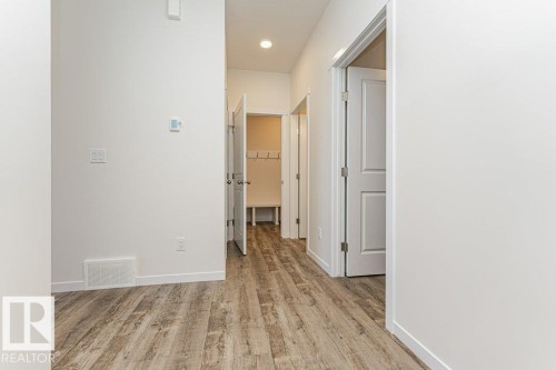 Hallway featuring wood-finish flooring, white walls, and recessed lighting - 6271 180 Avenue, Edmonton, AB - Indoor Photo Showing Other Room