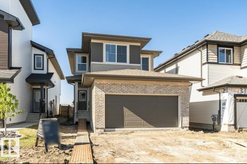 Contemporary two-story residence featuring a brick and siding exterior, an attached two-car garage, and multiple windows - 6271 180 Avenue, Edmonton, AB - Outdoor
