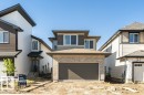 Contemporary two-story residence featuring a two-car garage, light brick facade, dark gray siding accents, and white window frames - 6271 180 Avenue, Edmonton, AB  - Outdoor With Exterior 