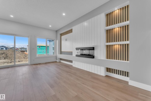 Spacious interior featuring wide plank wood-finish flooring and recessed lighting - 3116 8 Avenue, Edmonton, AB - Indoor With Fireplace