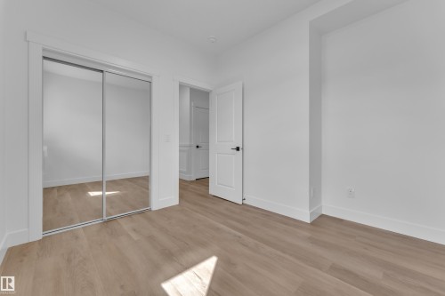 Room featuring light wood-finish flooring, white walls, and white trim - 3116 8 Avenue, Edmonton, AB - Indoor Photo Showing Other Room