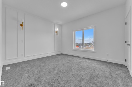 Neutral gray carpeting with white baseboards and walls - 3116 8 Avenue, Edmonton, AB - Indoor Photo Showing Other Room
