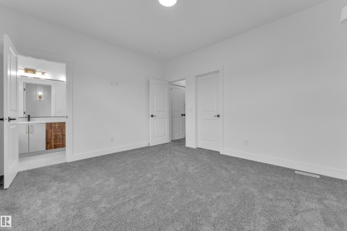 Interior room featuring neutral gray carpeting and white walls - 3116 8 Avenue, Edmonton, AB - Indoor Photo Showing Other Room