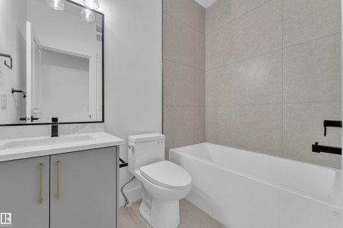 Bathroom featuring a modern vanity with a white countertop and rectangular sink - 3116 8 Avenue, Edmonton, AB - Indoor Photo Showing Bathroom