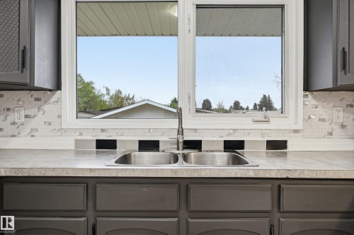 Kitchen double basin stainless steel sink with a gooseneck faucet - 13903 87 Street, Edmonton, AB - Indoor Photo Showing Kitchen With Double Sink