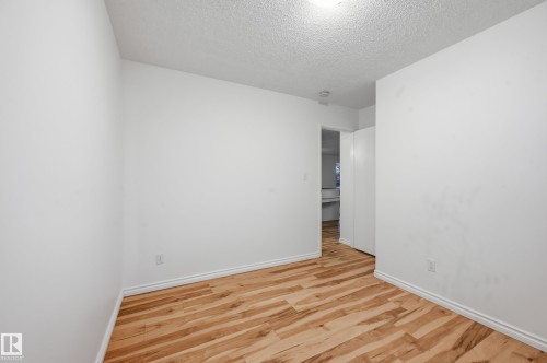 Room featuring light wood-finish flooring, white baseboards, and white walls - 13903 87 Street, Edmonton, AB - Indoor Photo Showing Other Room