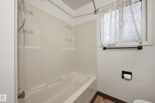 Integrated tub and shower combination with white surround - 13903 87 Street, Edmonton, AB - Indoor Photo Showing Bathroom