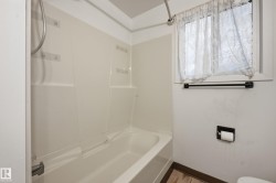 Integrated tub and shower combination with white surround - 