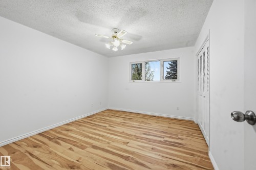 Room featuring wood-finish flooring, white baseboards, and a ceiling fan with integrated lighting - 13903 87 Street, Edmonton, AB - Indoor Photo Showing Other Room