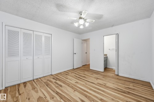 Room featuring wood-finish flooring, white walls, and a ceiling fan with integrated lighting - 13903 87 Street, Edmonton, AB - Indoor Photo Showing Other Room