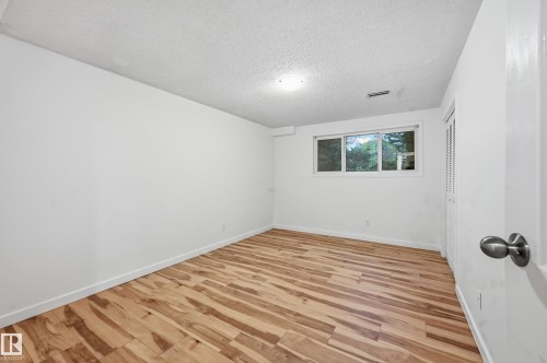 Room featuring light wood-finish flooring, white walls, and white baseboards - 13903 87 Street, Edmonton, AB - Indoor Photo Showing Other Room