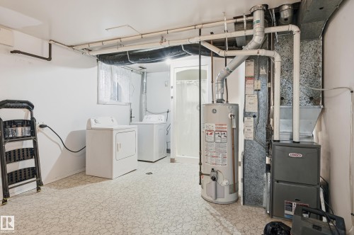 Utility area featuring a laundry space with a washer and dryer, a hot water heater, and a furnace unit - 13903 87 Street, Edmonton, AB - Indoor Photo Showing Laundry Room