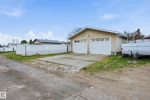 Detached two-car garage with white paneled doors and stucco exterior - 13903 87 Street, Edmonton, AB - Outdoor