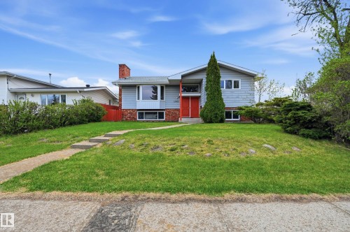 Split-level residence featuring light blue siding with red brick accents and a prominent red front door - 13903 87 Street, Edmonton, AB - Outdoor