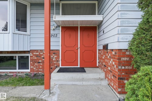 Inviting red double entry doors with decorative panels - 13903 87 Street, Edmonton, AB - Outdoor With Exterior