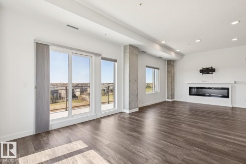 502 1316 Windermere Way, Edmonton, AB - Indoor Photo Showing Living Room With Fireplace