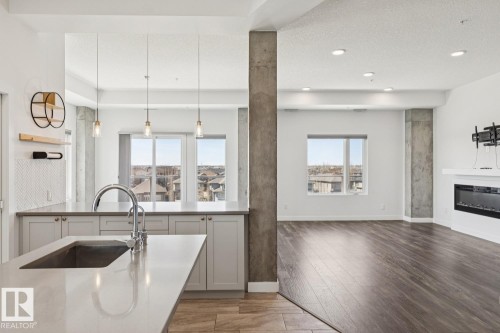 502 1316 Windermere Way, Edmonton, AB - Indoor Photo Showing Kitchen With Fireplace With Upgraded Kitchen