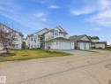 Contemporary multi-level residence featuring white siding and a dark shingle roof - 1340 Oakland Crescent, Devon, AB  - Outdoor With Facade 