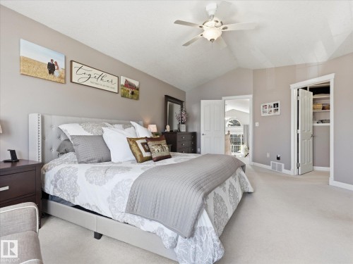 Spacious bedroom featuring vaulted ceilings, light neutral wall paint, and plush carpeting - 1340 Oakland Crescent, Devon, AB - Indoor Photo Showing Bedroom