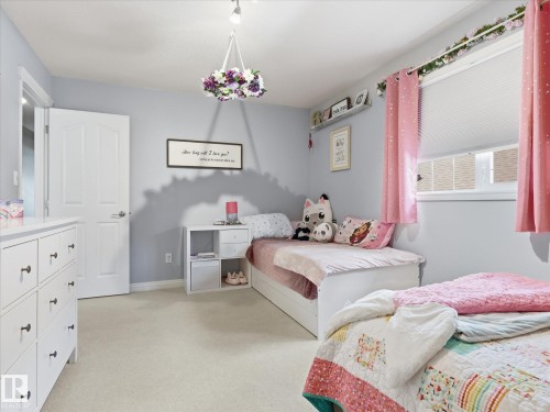 Light gray wall paint complemented by white baseboards and trim - 1340 Oakland Crescent, Devon, AB - Indoor Photo Showing Bedroom