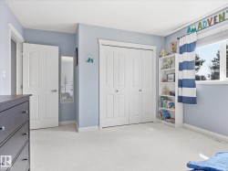 Light-filled room featuring soft blue walls and white trim - 