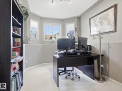 Bright room featuring track lighting, bay window, light gray paint, and carpet flooring - 
