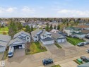 Residential property with a two-car garage, white siding, and a contrasting dark gray roof - 1340 Oakland Crescent, Devon, AB  - Outdoor With View 