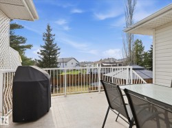 Outdoor elevated deck with a white railing system, offering ample space for entertaining - 