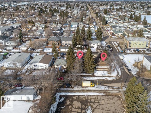 Aerial view showcasing the property within a residential neighborhood with surrounding trees and homes - 12942 68 Street, Edmonton, AB 