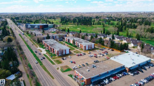 Aerial perspective showcasing a multi-lane roadway, commercial buildings, and multi-story residential structures - 3711 118 Street, Edmonton, AB - Outdoor With View