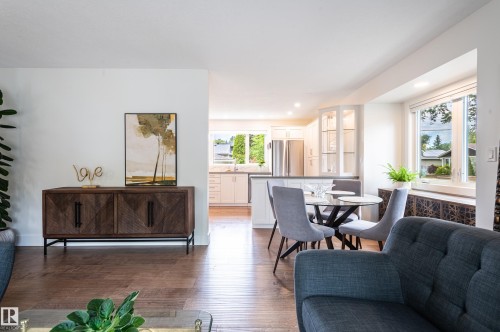 Open concept living area featuring wood-finish flooring, recessed lighting, and large windows - 14604 92A Avenue, Edmonton, AB - Indoor Photo Showing Living Room