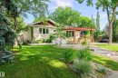 Exterior featuring horizontal siding, multiple windows, a front porch with a wooden pergola, and mature trees - 14604 92A Avenue, Edmonton, AB  - Outdoor 