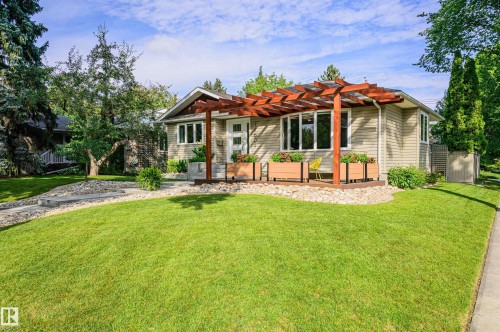Property exterior featuring a prominent wooden pergola over a front deck - 14604 92A Avenue, Edmonton, AB - Outdoor