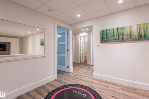 Bright interior space featuring wood-finish flooring, white walls, and recessed lighting - 14604 92A Avenue, Edmonton, AB - Indoor Photo Showing Other Room