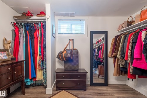 Dedicated storage space featuring wood-finish flooring, white walls, and a transom window with blinds - 14604 92A Avenue, Edmonton, AB - Indoor With Storage