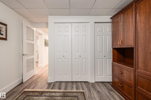 Wood-finish flooring complemented by a drop ceiling - 14604 92A Avenue, Edmonton, AB - Indoor