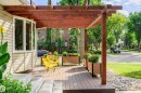 Expansive wood-finish deck featuring a substantial pergola, multiple planter boxes, and a stone-edged garden bed - 14604 92A Avenue, Edmonton, AB  - Outdoor With Deck Patio Veranda With Exterior 