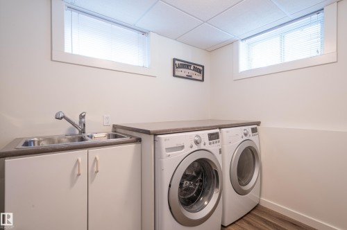 Utility space featuring a built-in stainless steel sink, lower cabinetry, and a countertop surface - 14604 92A Avenue, Edmonton, AB - Indoor Photo Showing Laundry Room